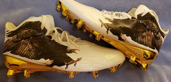 white football cleats with gold bottom